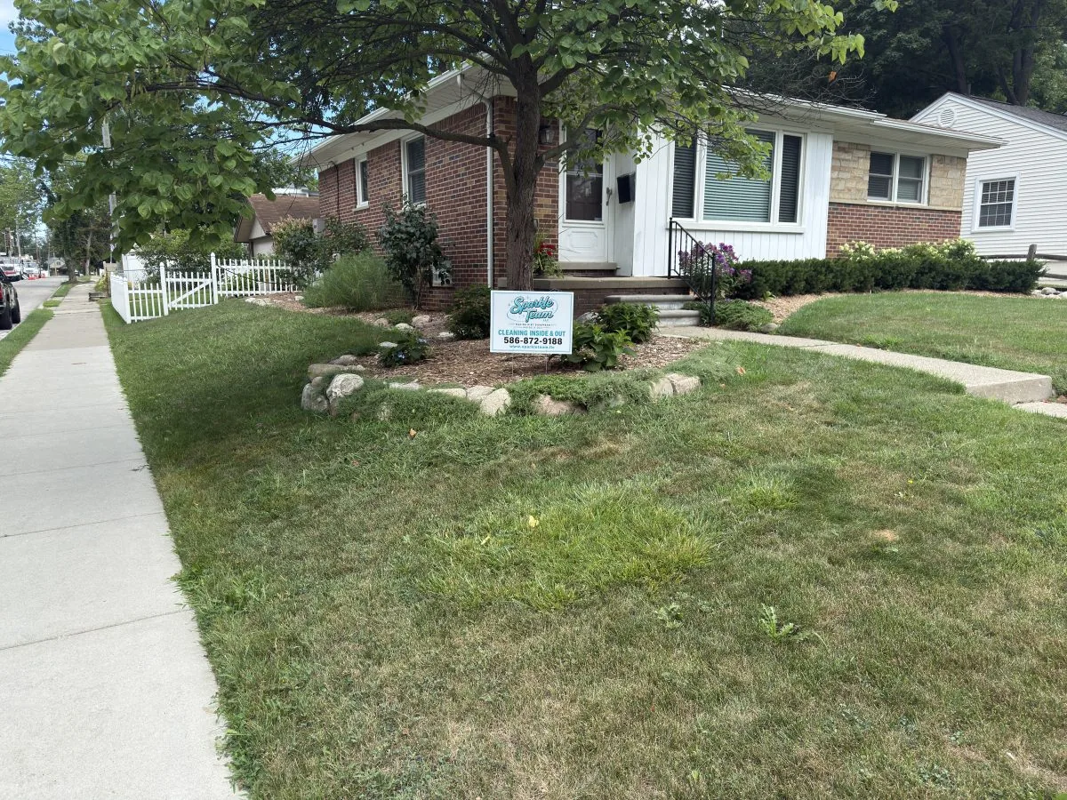 Residential home with a Sparkle Team cleaning sign displayed near the front entrance